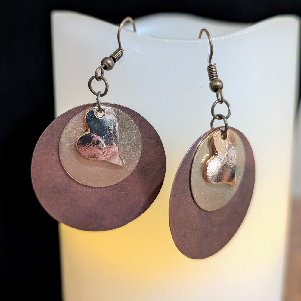Circle discs and heart drop earrings in gold and bronze.